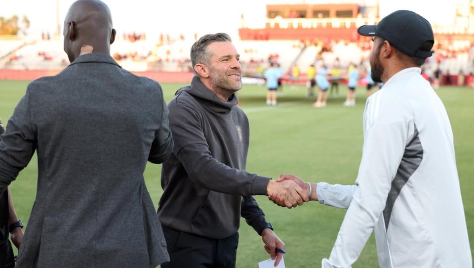 Ben Olsen shakes hand with manager before Open Cup match