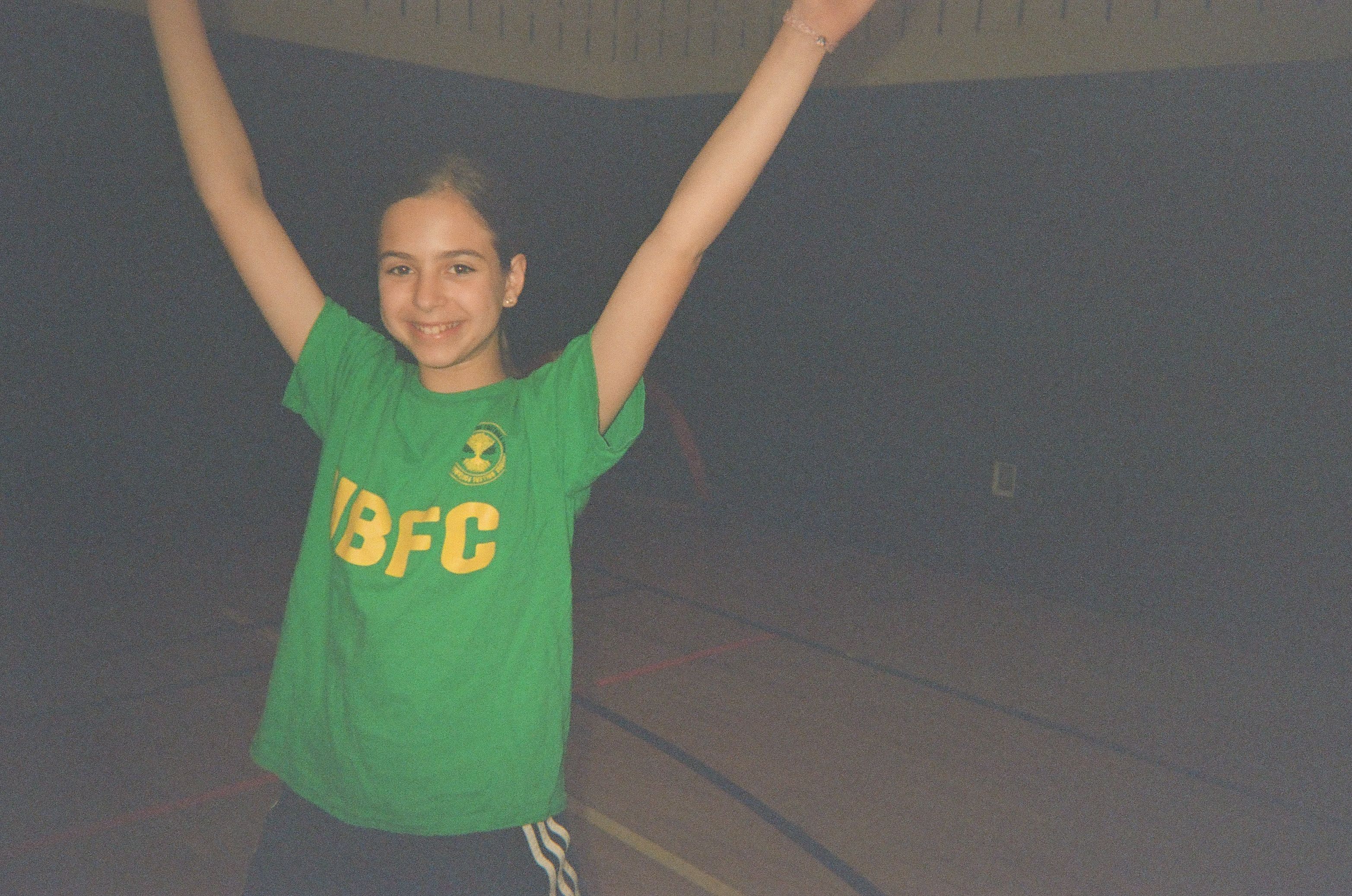 A young girl with her hands in the air.
