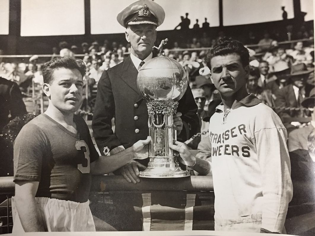 1944 Open Cup/National Challenge Cup-winning captain Frankie Fernandez of Brooklyn Hispano poses at the Polo Grounds with the Dewar Cup (the original Open Cup/National Challenge Cup trophy). 