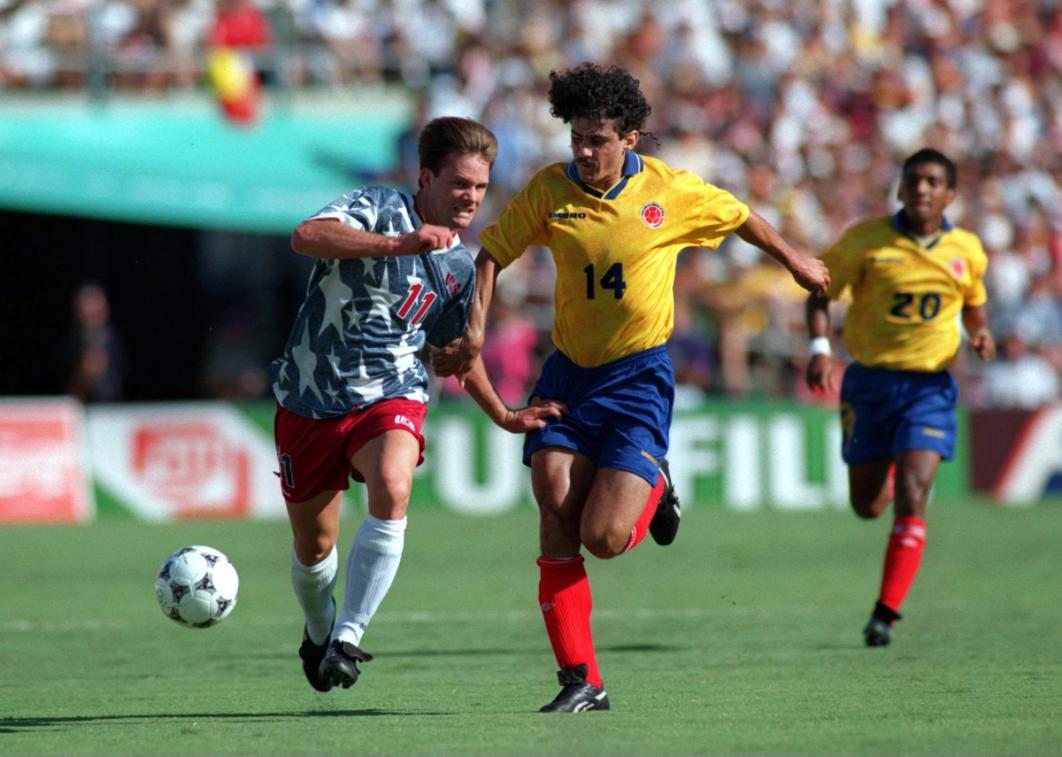 The USMNT's Eric Wynalda pulled back by Colombia's Leonel Alvarez during the USMNT-Colombia match in the 1994 FIFA World Cup (Photo Credit: Shaun Botterill/Allsport)