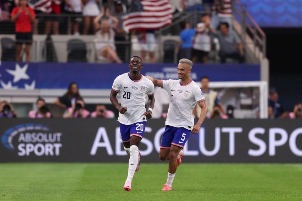 Folarin Balogun and Antonee Robinson running on the pitch in celebration during the USA's Copa America match against Bolivia