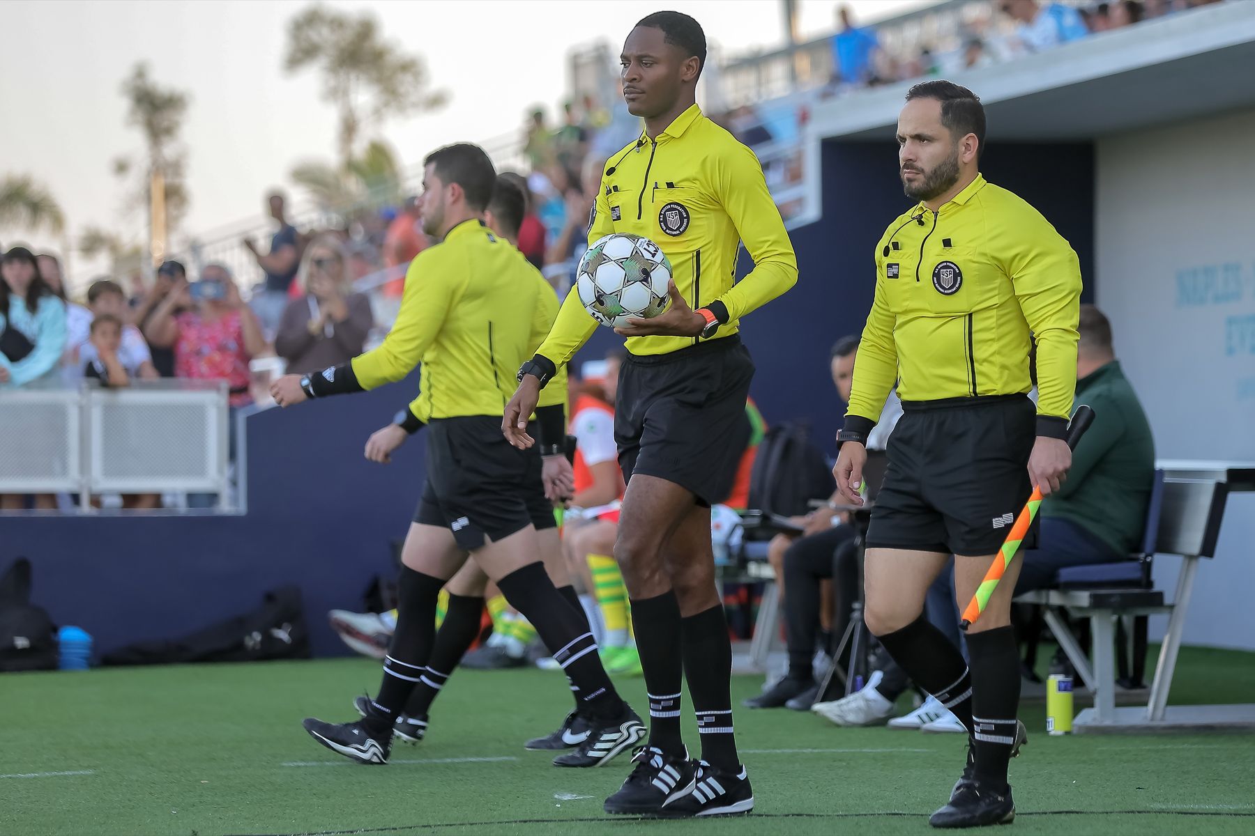 Referee crew walking onto the field