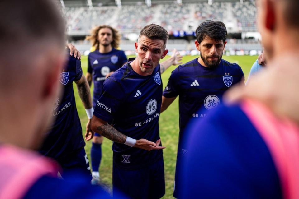 Louisville City players in a pregame huddle
