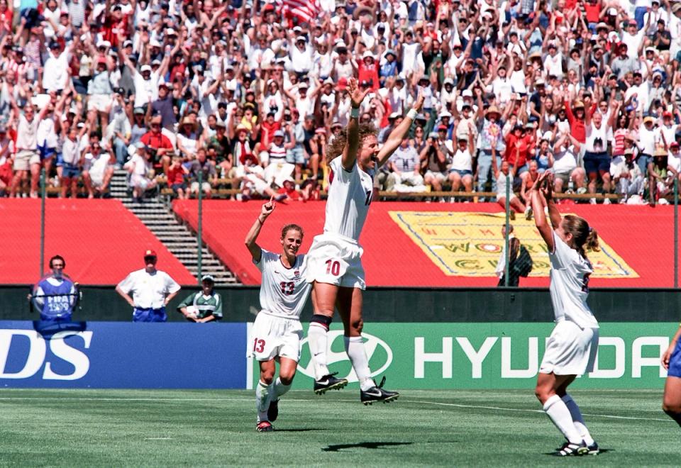 USWNT players jump in celebration during their match against Brazil