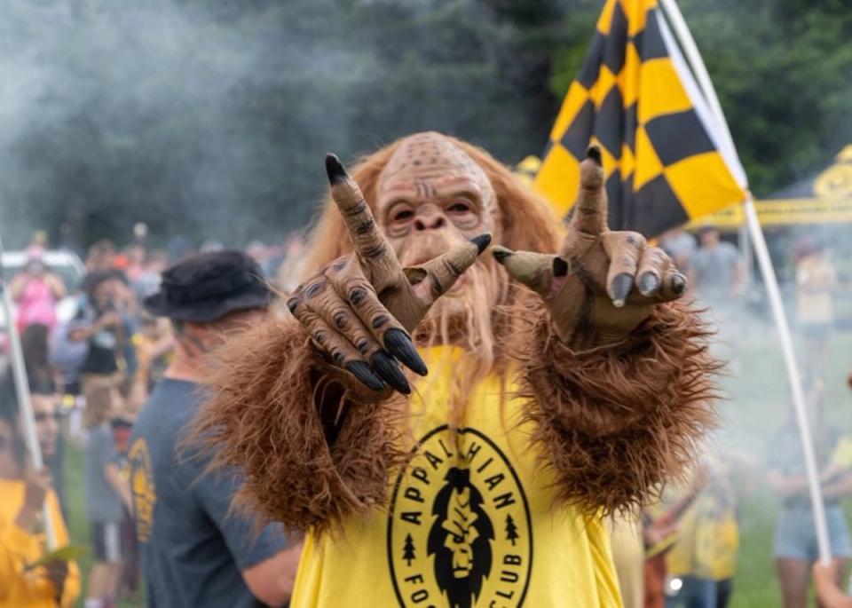 Appalachian FC Sasquach holds up hands to the camera