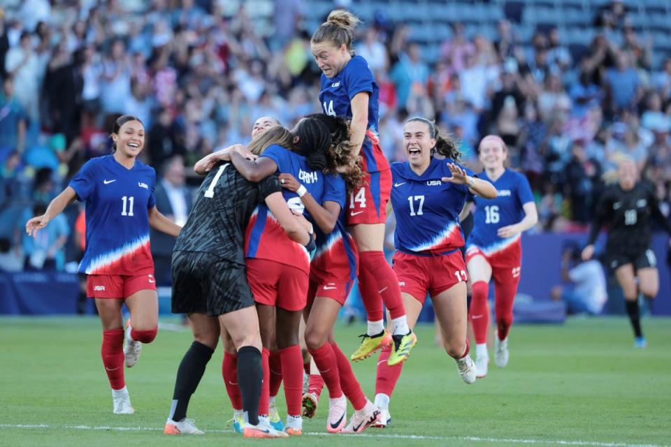 USWNT players jump in celebration on the field