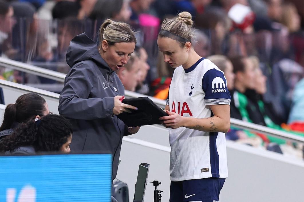 Vicky Jepsen studies tablet with Tottenham Hotspur player