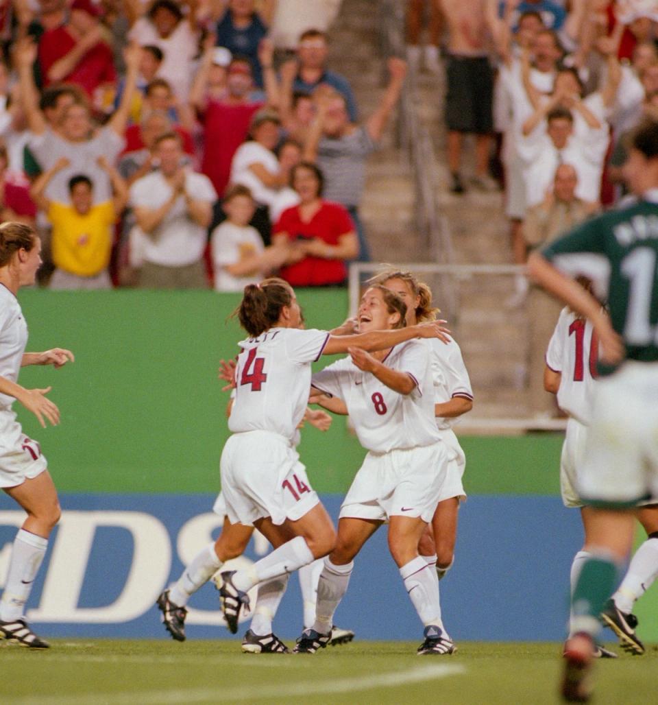 Joy Fawcett and Shannon MacMillan celebrate on the field after scoring the go-ahead goal
