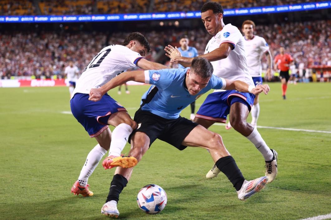 Christian Pulisic and Tyler Adams fight for the ball against a player for the Uruguay National Team during a July 1 Copa America match