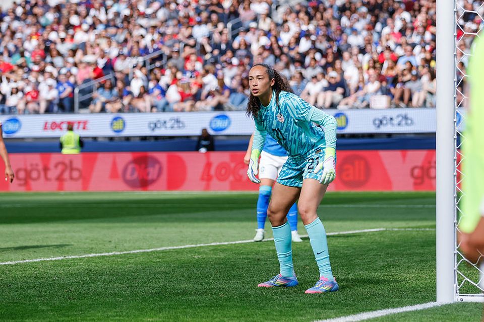 photo of phallon tullis joyce wearing blue on the field defending the goal