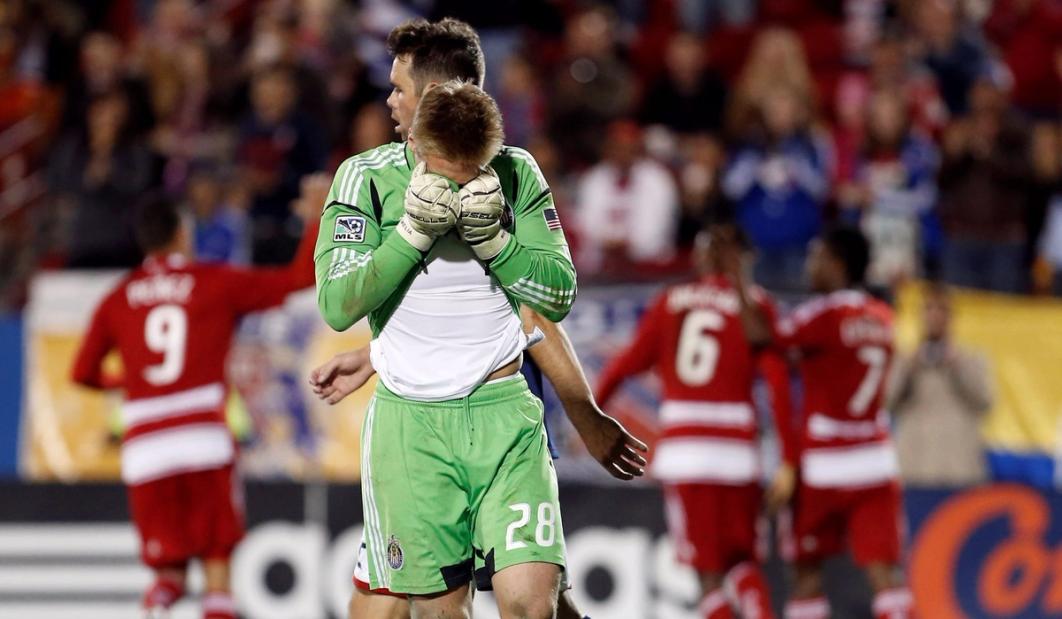 Tim Melia in green with his head in his hands during a match