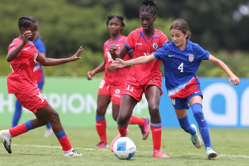 Loradana Paletta dribbling the ball past three defenders during match versus Haiti.