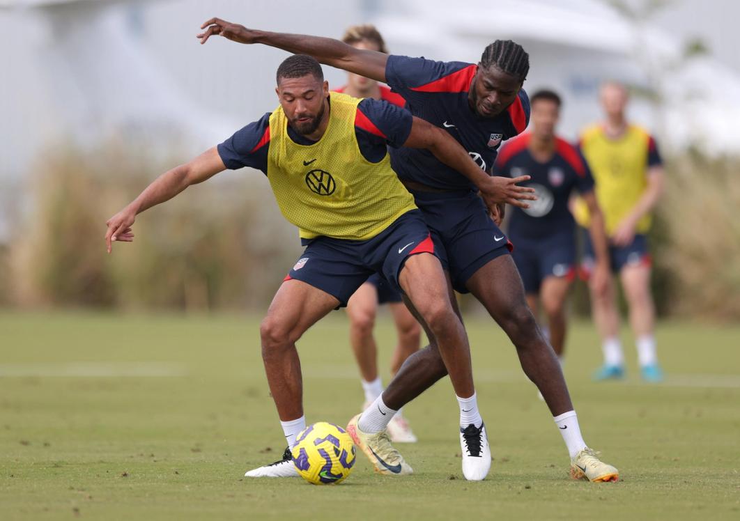 George Campbell and Patrick Agyemang battle for the ball during training