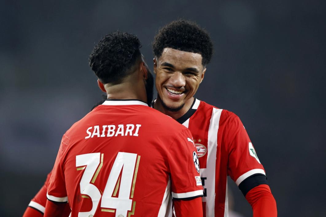 Malik Tillman celebrates with a teammate after scoring a goal for PSV