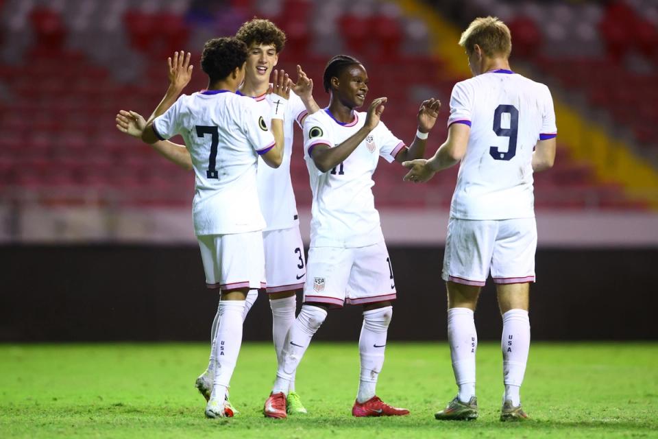 Players on the US U17 MNT celebrate on the field following a match