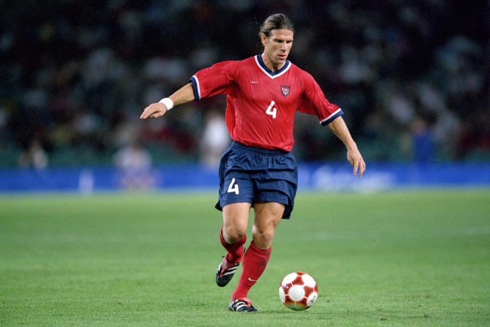 jeff agoos in red dribbling the ball