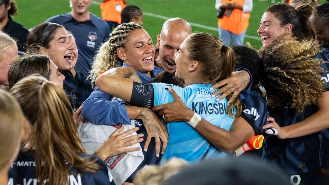Trinity Rodman and Audrey Kingsbury celebrate with the Washington Spirit team after a match