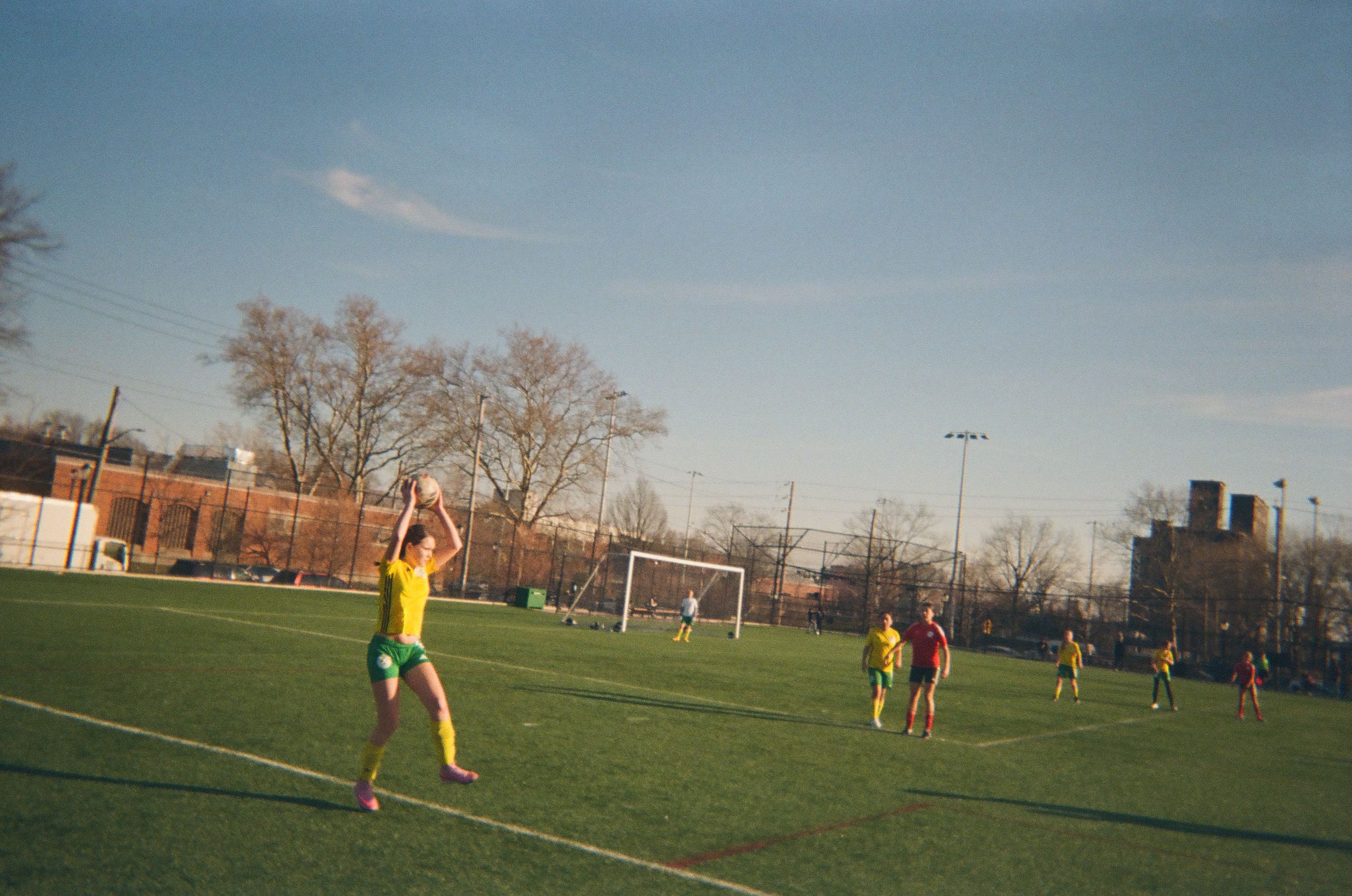 A girl taking a sideline throw during a football game.