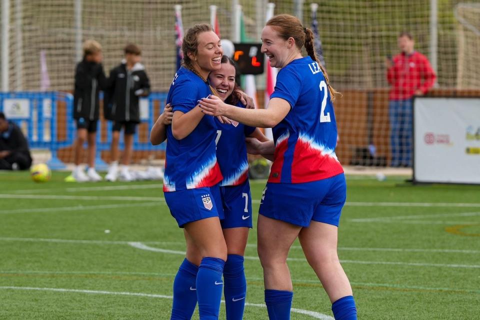 Three members of the CP WNT celebrate on the field