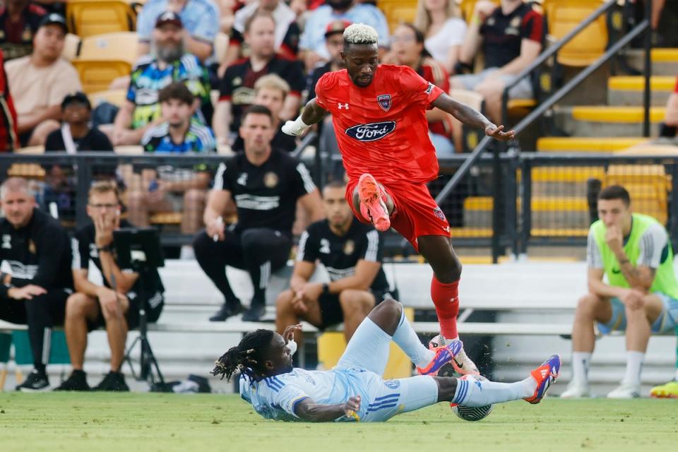 Indy Eleven player Augi Williams navigates the ball around a slide tackle from Atlanta United