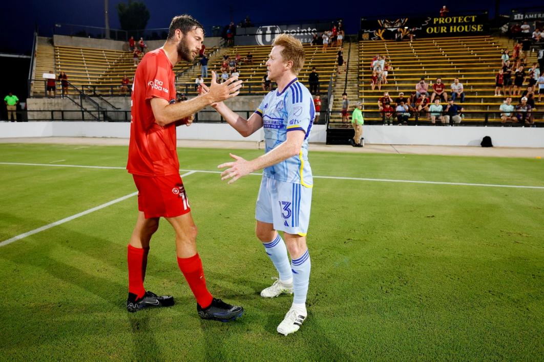 Dax McCarty congratulating Indy Eleven players after the final whistle in Kennesaw