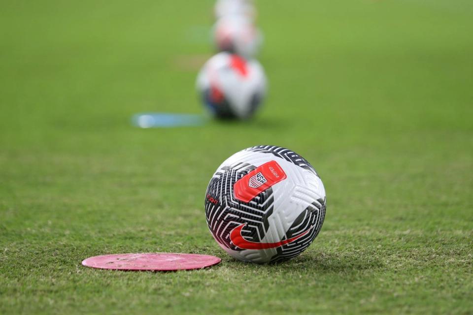 black white and red us soccer ball on field