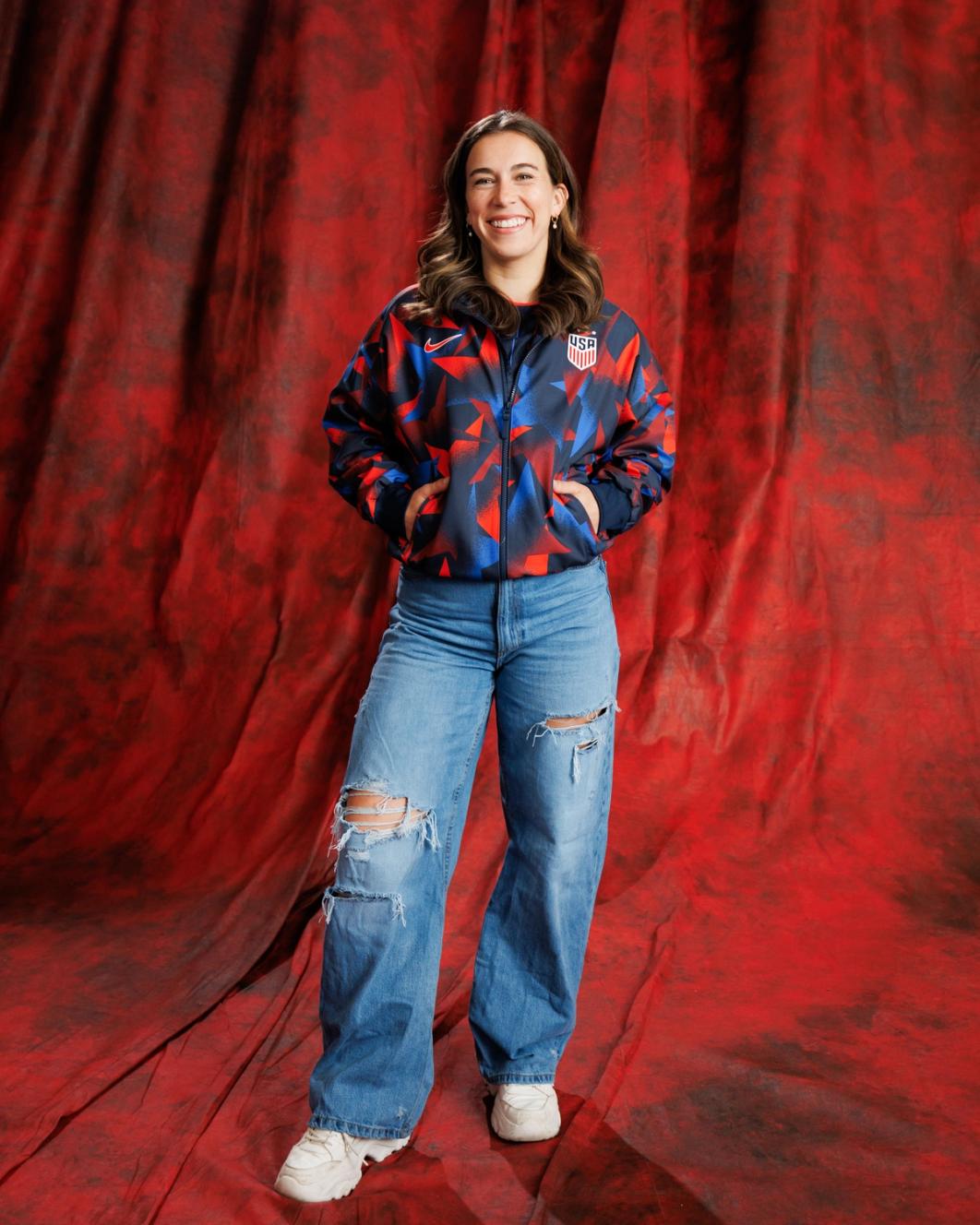 Sam Coffey wearing blue and red geometric anthem jacket