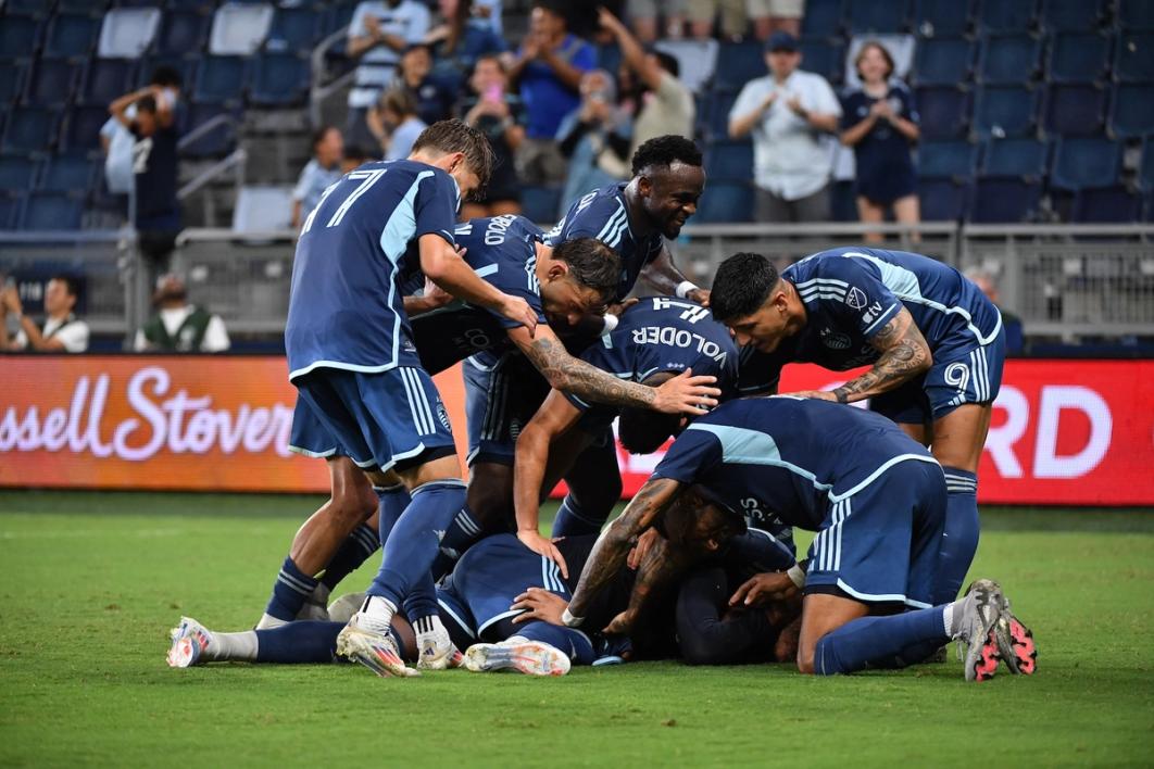 Sporting Kansas City players pile on in celebration on the field during a US Open Cup match against FC Dallas