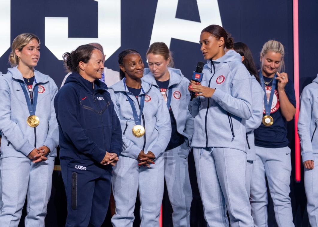 Twila Kilgore on stage being recognized by the gold medal winning US Olympic Women's Soccer Team