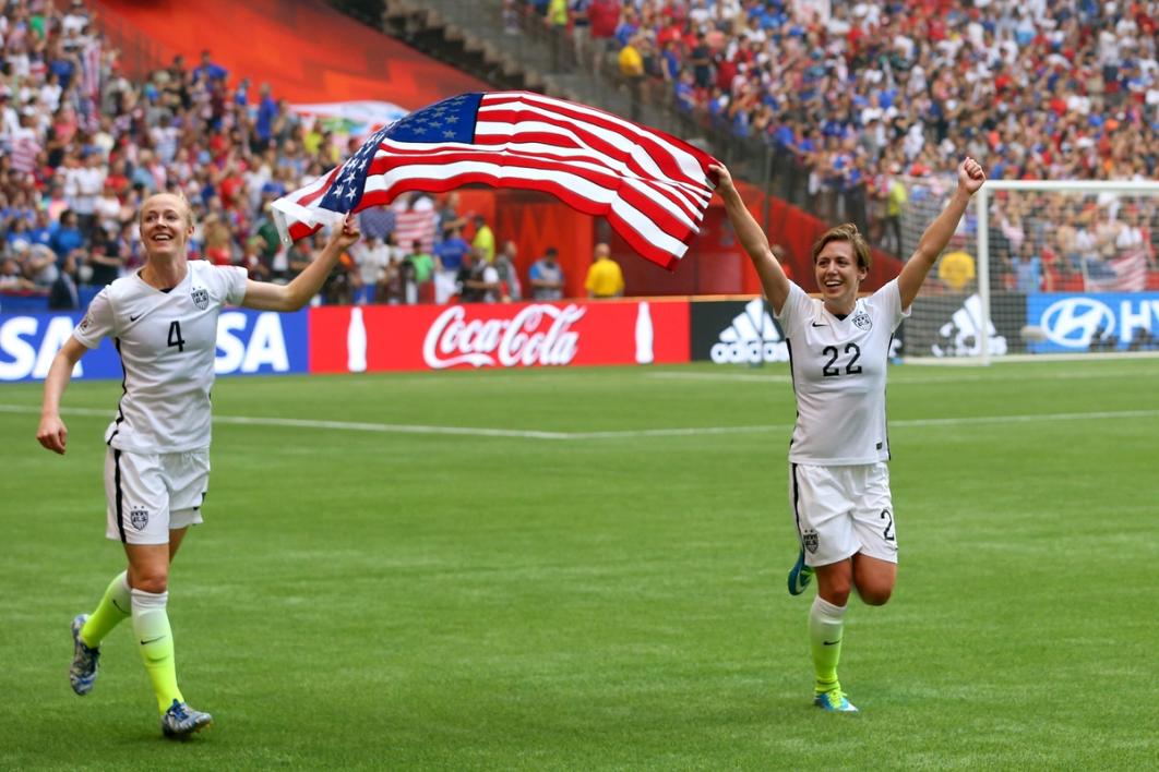 Sauerbrunn and Meghan Klingenberg waving the United States flag after winning 2015 World Cup Final