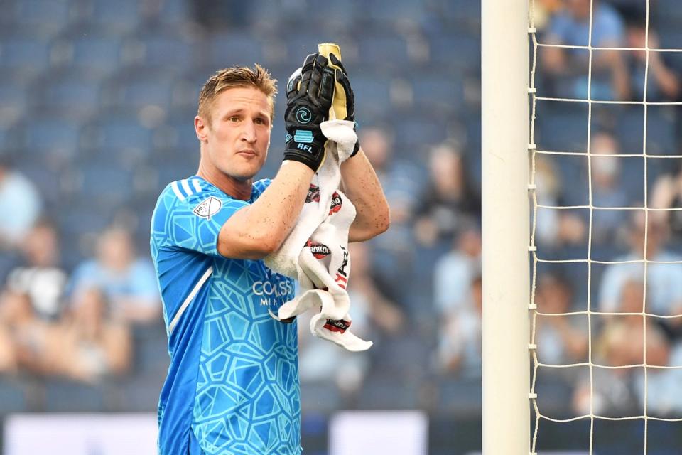 Goalkeeper Tim Melia claps his hands together and looks towards the crowd