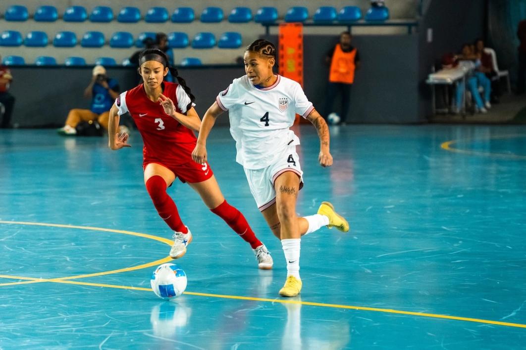 Ashley Henderson dribbles past Canadian defender