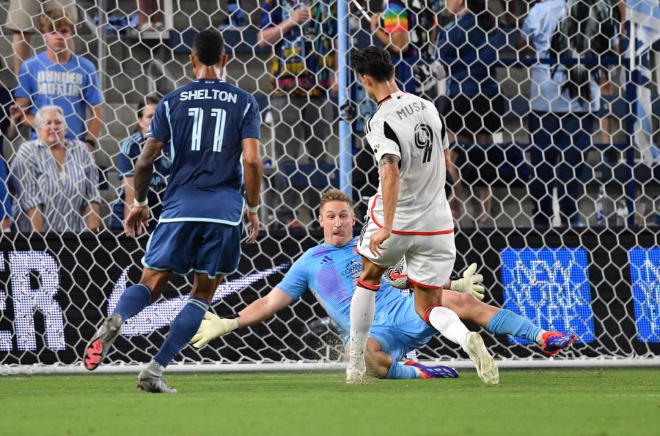 Melia giving to his right as a ball heads towards net during an Open Cup match