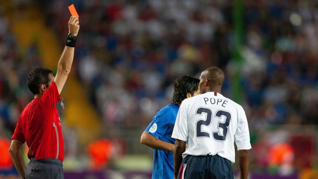 Jorge Larrionda issues a red card to Eddie Pope for his tackle on Italy’s Alberto Gilardino the FIFA World Cup Group E match between Italy and USA at the Fritz-Walter Stadium on June 17, 2006, in Kaiserslautern, Germany. (Photo by Simon Bruty/Anychance/Getty Images)