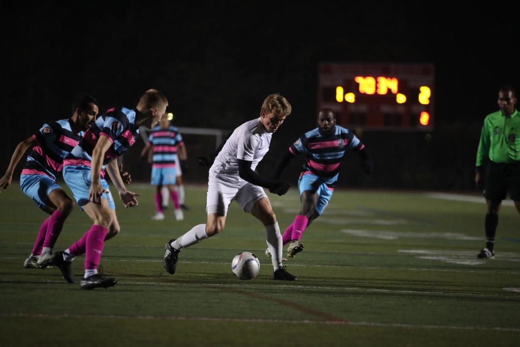 CD Faialense and Project Football players contest a ball during a match