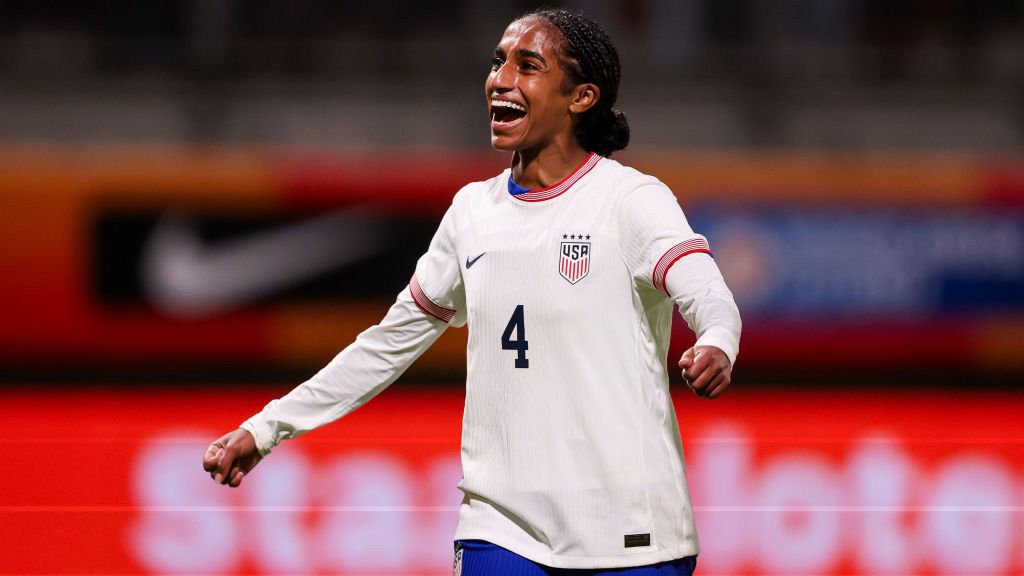 Naomi Girma smiling wearing white USWNT shirt