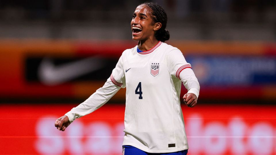 Naomi Girma smiling wearing white USWNT shirt
