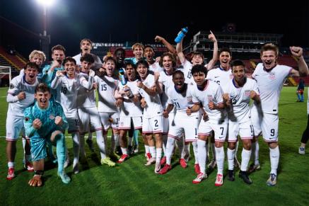 Mens Youth National Team players cheer towards the camera after a match