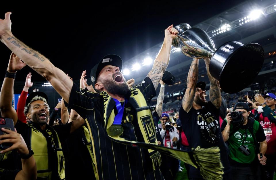 Olivier Giroud holds the U.S. Open Cup trophy in celebration