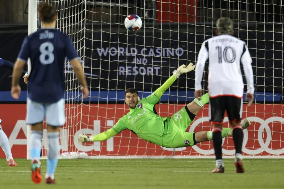 Paes dives for a save in goal during a match