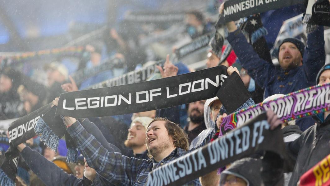 fan waving scarf that reads legion of loons