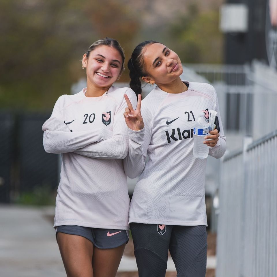 Alyssa and Gisele pose for a picture after a training session