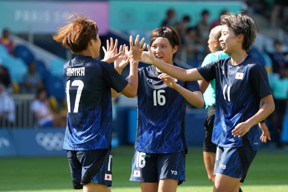 Members of the Japanese National Team celebrate on the field