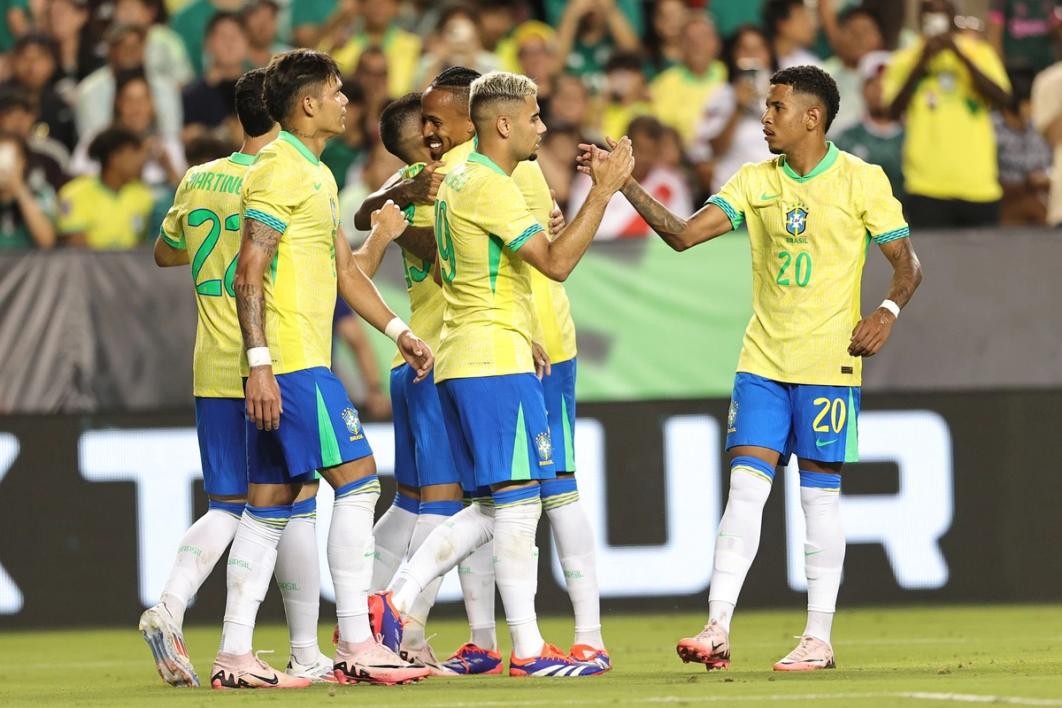 six brazilian players on the field in yellow shirts and blue shorts