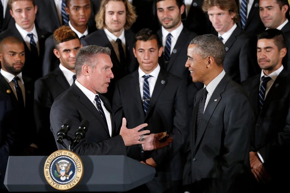 Vermes with President Barack Obama at the White House in suits with players in the background