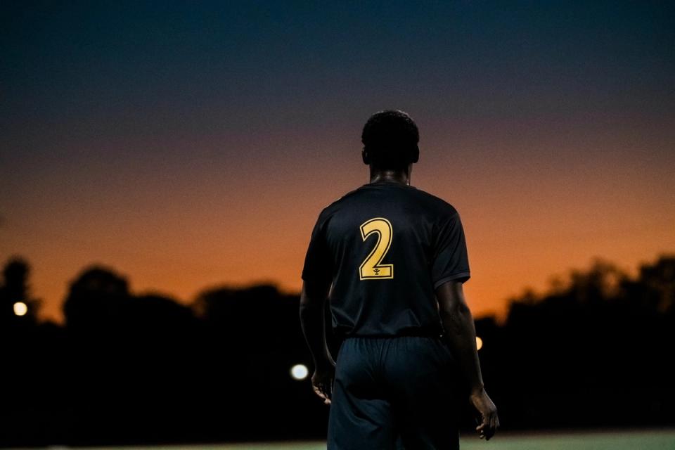 A photo behind a player in the US Open Cup with the sunsetting in the background