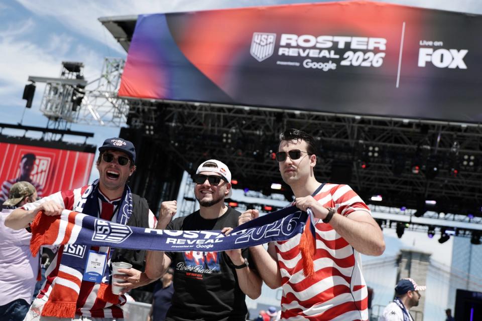 Fans pose in front of the main stage prior to the roster reveal in New York City. (Photo by Adam Hunger/Getty Images)