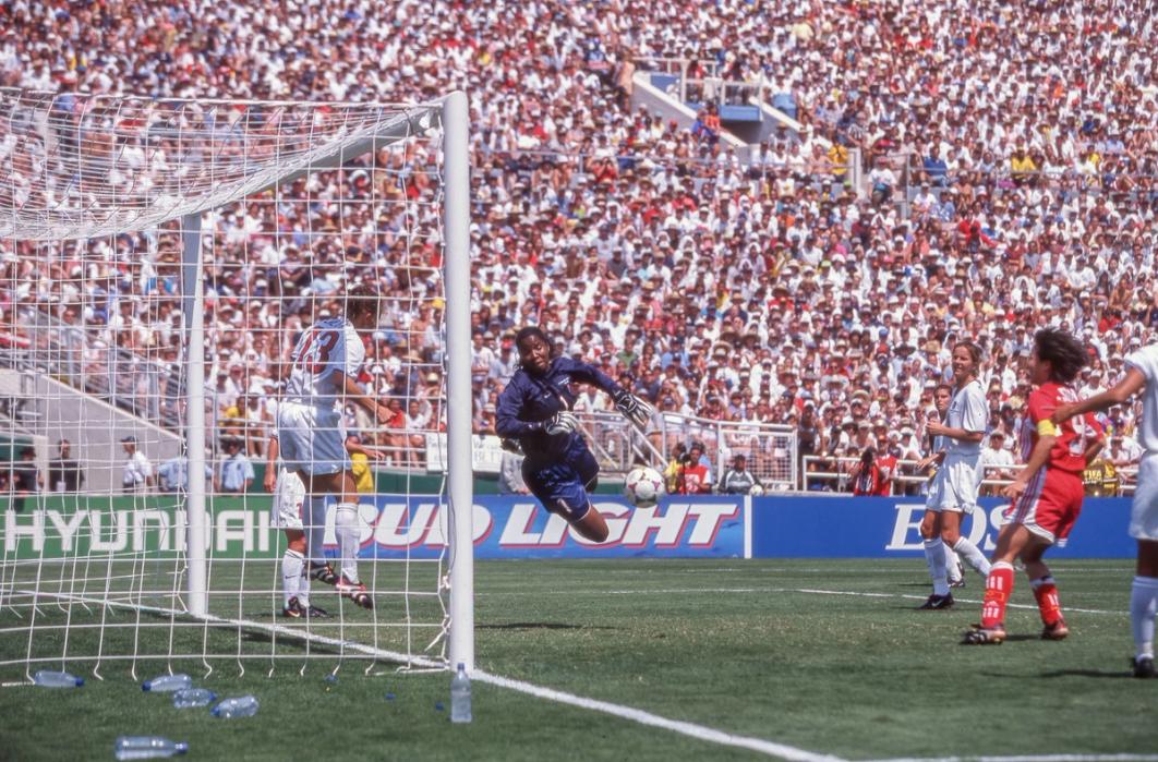 Kristine Lilly on the goal line preparing to deflect a ball heading towards goal while Briana Scurry dives for it in the background​​​​‌﻿‍﻿​‍​‍‌‍﻿﻿‌﻿​‍‌‍‍‌‌‍‌﻿‌‍‍‌‌‍﻿‍​‍​‍​﻿‍‍​‍​‍‌﻿​﻿‌‍​‌‌‍﻿‍‌‍‍‌‌﻿‌​‌﻿‍‌​‍﻿‍‌‍‍‌‌‍﻿﻿​‍​‍​‍﻿​​‍​‍‌‍‍​‌﻿​‍‌‍‌‌‌‍‌‍​‍​‍​﻿‍‍​‍​‍‌‍‍​‌﻿‌​‌﻿‌​‌﻿​​‌﻿​﻿​﻿‍‍​‍﻿﻿​‍﻿﻿‌﻿‌‌‌﻿​﻿‌﻿​﻿‌‍‌‍​‍﻿‍‌﻿​﻿‌‍​‌‌‍﻿‍‌‍‍‌‌﻿‌​‌﻿‍‌​‍﻿‍‌﻿​﻿‌﻿‌​‌﻿‌‌‌‍‌​‌‍‍‌‌‍﻿﻿​‍﻿﻿‌‍‍‌‌‍﻿‍‌﻿‌​‌‍‌‌‌‍﻿‍‌﻿‌​​‍﻿﻿‌‍‌‌‌‍‌​‌‍‍‌‌﻿‌​​‍﻿﻿‌‍﻿‌‌‍﻿﻿‌‍‌​‌‍‌‌​﻿﻿‌‌﻿​​‌﻿​‍‌‍‌‌‌﻿​﻿‌‍‌‌‌‍﻿‍‌﻿‌​‌‍​‌‌﻿‌​‌‍‍‌‌‍﻿﻿‌‍﻿‍​﻿‍﻿‌‍‍‌‌‍‌​​﻿﻿‌​﻿‍‌‌‍​‍‌‍‌​​﻿‌‌​﻿​​​﻿‌﻿‌‍​‌​﻿‍​​‍﻿‌​﻿​​​﻿‍‌​﻿‌‌​﻿‍​​‍﻿‌​﻿‌​​﻿​‍‌‍​‌‌‍​‌​‍﻿‌​﻿‍​​﻿‌‌​﻿‍​​﻿‌‌​‍﻿‌​﻿‌​​﻿​‍​﻿‌‌​﻿​﻿​﻿‌﻿​﻿​‍​﻿​‌​﻿​‍‌‍​﻿​﻿‍‌‌‍​‌​﻿‌‌​﻿‍﻿‌﻿‌​‌﻿‍‌‌﻿​​‌‍‌‌​﻿﻿‌‌﻿​﻿‌﻿‌​‌‍﻿﻿‌﻿​‍‌﻿‍‌​﻿‍﻿‌﻿​​‌‍​‌‌﻿‌​‌‍‍​​﻿﻿‌‌‍​﻿‌‍﻿﻿‌‍﻿‍‌﻿‌​‌‍‌‌‌‍﻿‍‌﻿‌​​‍‌‌​﻿‌‌‌​​‍‌‌﻿﻿‌‍‍﻿‌‍‌‌‌﻿‍‌​‍‌‌​﻿​﻿‌​‌​​‍‌‌​﻿​﻿‌​‌​​‍‌‌​﻿​‍​﻿​‍​﻿‌﻿‌‍​﻿‌‍‌‌‌‍‌​​﻿‌​​﻿‍​​﻿​‍​﻿​﻿​﻿‍​​﻿‌​​﻿​﻿​﻿‍‌​‍‌‌​﻿​‍​﻿​‍​‍‌‌​﻿‌‌‌​‌​​‍﻿‍‌‍‍‌‌‍﻿‌‌‍​‌‌‍‌﻿‌‍‌‌​‍﻿‍‌‍​‌‌‍﻿​‌﻿‌​​﻿﻿﻿‌‍​‍‌‍​‌‌﻿​﻿‌‍‌‌‌‌‌‌‌﻿​‍‌‍﻿​​﻿﻿‌‌‍‍​‌﻿‌​‌﻿‌​‌﻿​​‌﻿​﻿​‍‌‌​﻿​﻿‌​​‌​‍‌‌​﻿​‍‌​‌‍​‍‌‌​﻿​‍‌​‌‍‌﻿‌‌‌﻿​﻿‌﻿​﻿‌‍‌‍​‍﻿‍‌﻿​﻿‌‍​‌‌‍﻿‍‌‍‍‌‌﻿‌​‌﻿‍‌​‍﻿‍‌﻿​﻿‌﻿‌​‌﻿‌‌‌‍‌​‌‍‍‌‌‍﻿﻿​‍‌‍‌‍‍‌‌‍‌​​﻿﻿‌​﻿‍‌‌‍​‍‌‍‌​​﻿‌‌​﻿​​​﻿‌﻿‌‍​‌​﻿‍​​‍﻿‌​﻿​​​﻿‍‌​﻿‌‌​﻿‍​​‍﻿‌​﻿‌​​﻿​‍‌‍​‌‌‍​‌​‍﻿‌​﻿‍​​﻿‌‌​﻿‍​​﻿‌‌​‍﻿‌​﻿‌​​﻿​‍​﻿‌‌​﻿​﻿​﻿‌﻿​﻿​‍​﻿​‌​﻿​‍‌‍​﻿​﻿‍‌‌‍​‌​﻿‌‌​‍‌‍‌﻿‌​‌﻿‍‌‌﻿​​‌‍‌‌​﻿﻿‌‌﻿​﻿‌﻿‌​‌‍﻿﻿‌﻿​‍‌﻿‍‌​‍‌‍‌﻿​​‌‍​‌‌﻿‌​‌‍‍​​﻿﻿‌‌‍​﻿‌‍﻿﻿‌‍﻿‍‌﻿‌​‌‍‌‌‌‍﻿‍‌﻿‌​​‍‌‌​﻿‌‌‌​​‍‌‌﻿﻿‌‍‍﻿‌‍‌‌‌﻿‍‌​‍‌‌​﻿​﻿‌​‌​​‍‌‌​﻿​﻿‌​‌​​‍‌‌​﻿​‍​﻿​‍​﻿‌﻿‌‍​﻿‌‍‌‌‌‍‌​​﻿‌​​﻿‍​​﻿​‍​﻿​﻿​﻿‍​​﻿‌​​﻿​﻿​﻿‍‌​‍‌‌​﻿​‍​﻿​‍​‍‌‌​﻿‌‌‌​‌​​‍﻿‍‌‍‍‌‌‍﻿‌‌‍​‌‌‍‌﻿‌‍‌‌​‍﻿‍‌‍​‌‌‍﻿​‌﻿‌​​‍‌‍‌‍‍‌‌﻿​﻿‌​‌​‌﻿​‍‌‍​‌‌‍‌‍‌﻿‌​​﻿﻿‌​‍​‍‌﻿﻿‌