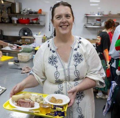 a room filled with shelves filled with cans and bags of food .