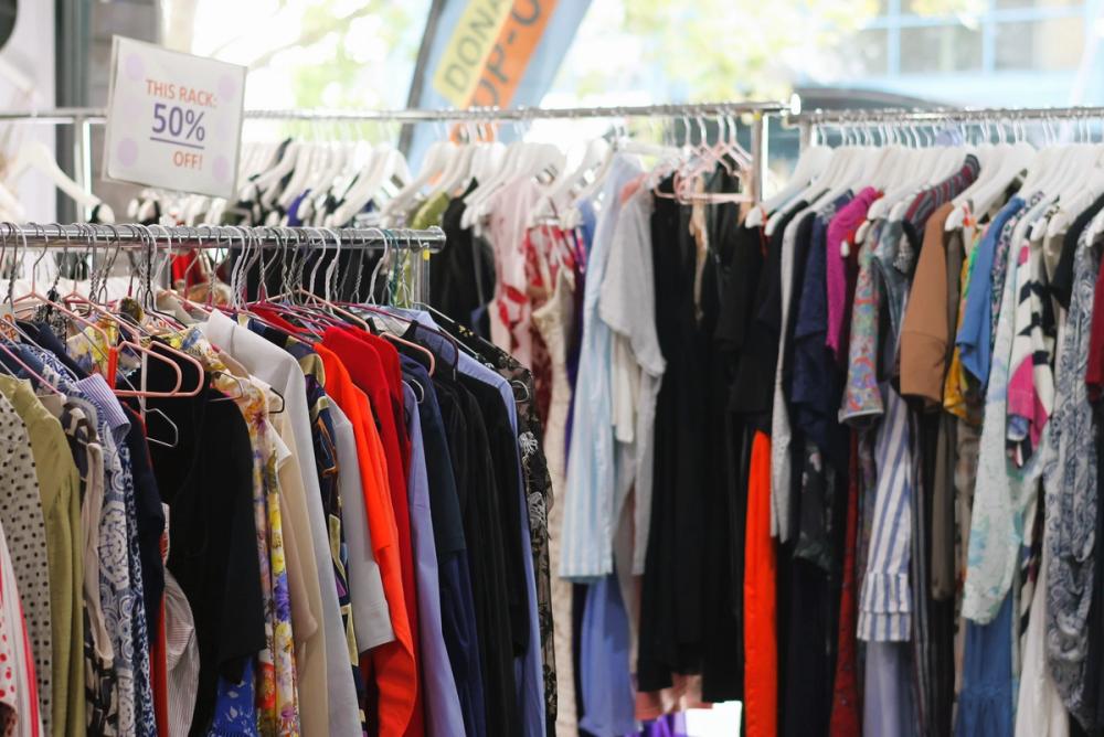 a man and a woman are standing next to each other on a sidewalk .